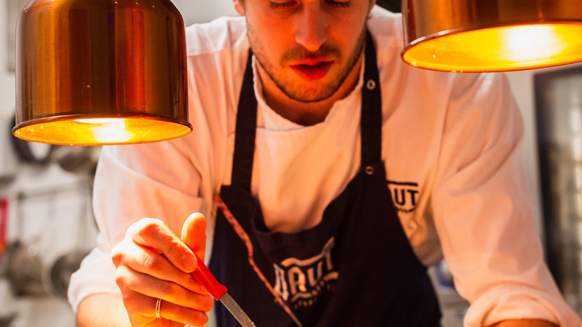 Chef cuisinier dressant une assiette pour les publications locales